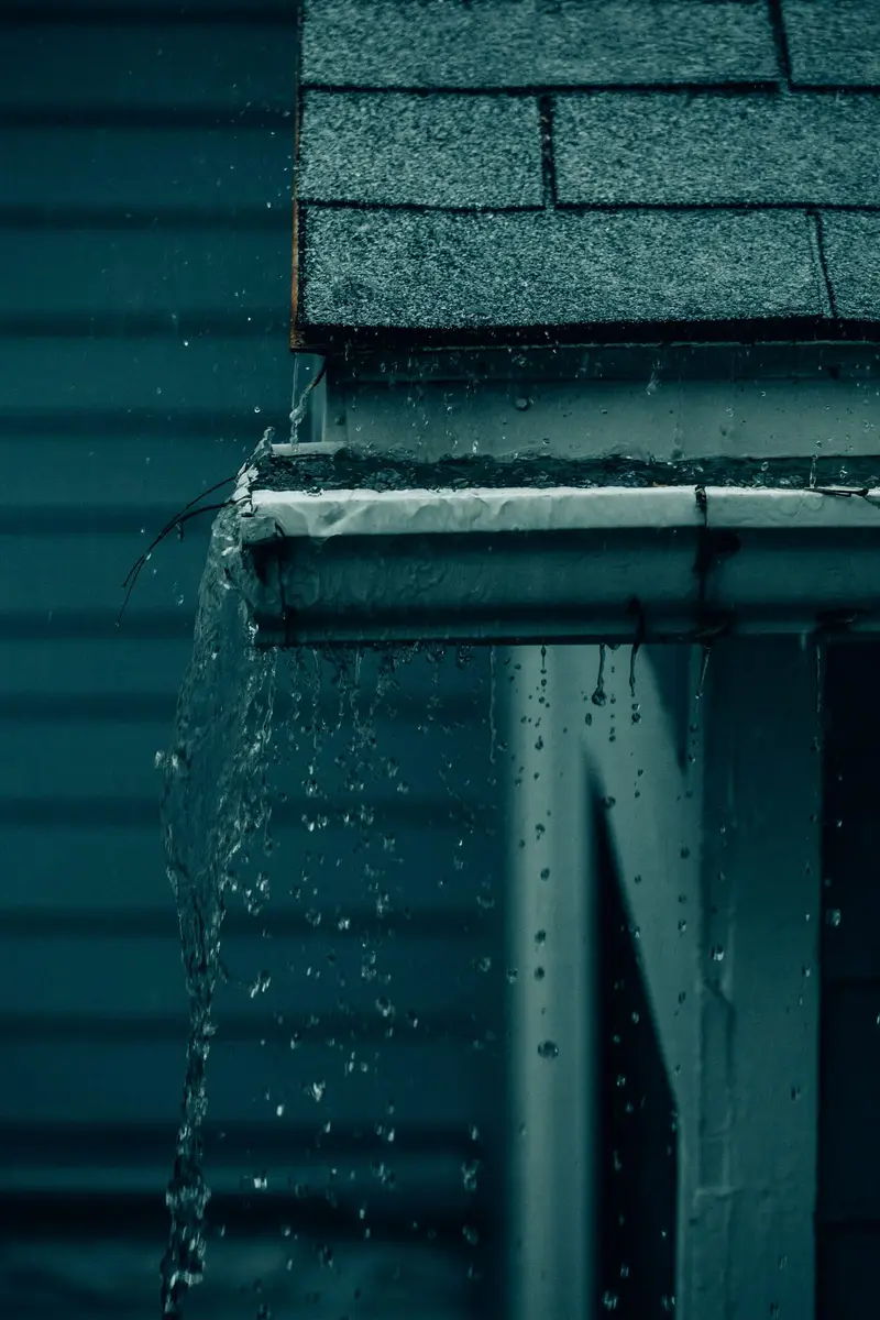 Rainwater spilling over the edge of a gutter